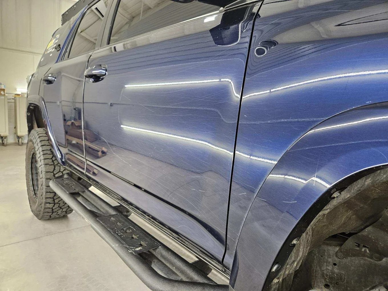 Scratched blue 4Runner paint before correction
